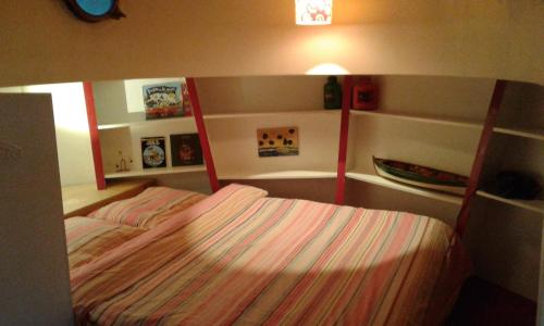 a bedroom with a bed with two bunk beds at Houseboat Dokstroom in Amsterdam