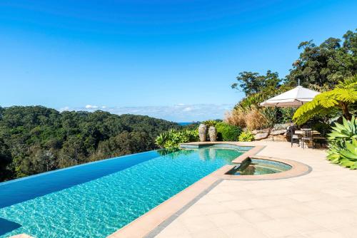 a swimming pool with a view of the mountains at The Outlook Cabana in Terrigal