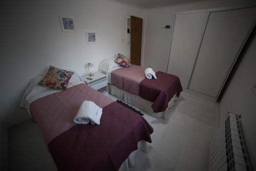 a room with two beds and two tables at Aparthotel Aldea Termal in Copahue