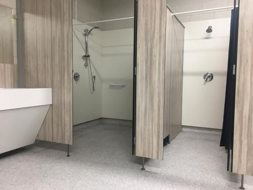 a bathroom with a shower and a sink at Stratford Motel & Holiday Park in Stratford