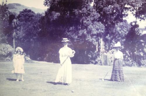 an old photo of three people standing in a field at Blythcliffe in Akaroa