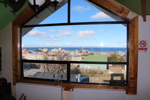 a window with a view of the city at Hostal Fernando de Magalhaes in Punta Arenas