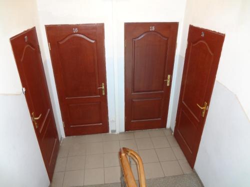 a hallway with two wooden doors in a room at ApartHotel Riga in Rīga