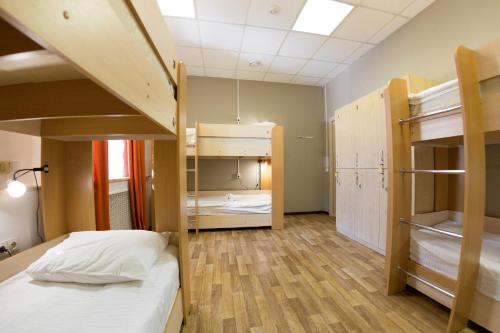 a dorm room with bunk beds and wooden floors at Z Hostel in Irkutsk