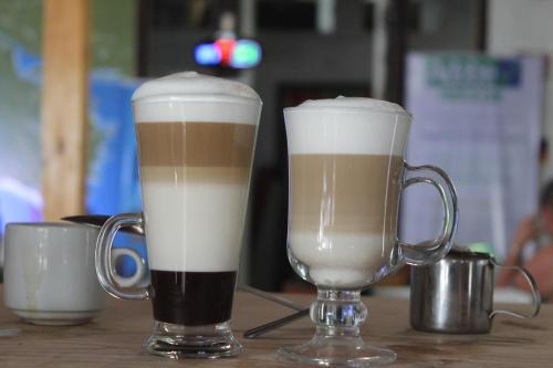 two cups of coffee sitting on top of a table at Hotel Aldea Pura Vida in Puntarenas