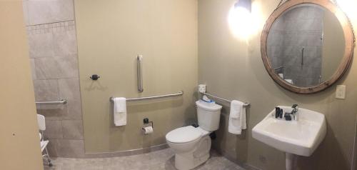 a bathroom with a toilet and a sink and a mirror at Canyon Country Lodge in Escalante