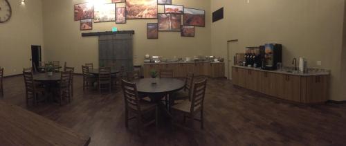a restaurant with tables and chairs and a bar at Canyon Country Lodge in Escalante