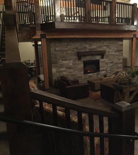 a living room with a stone fireplace with couches at Canyon Country Lodge in Escalante