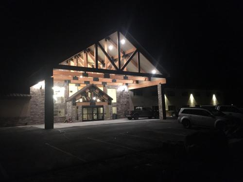 a building with cars parked in a parking lot at night at Canyon Country Lodge in Escalante