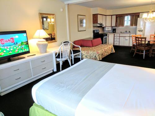 a bedroom with a large bed and a living room at Quebec Motel in Wildwood