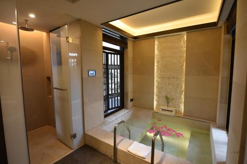 a bathroom with a bath tub with a shower at E-mei Mountain Hotel in Emeishan
