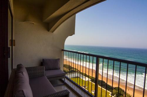 a balcony with a view of the beach at 803 Bermudas - by Stay in Umhlanga in Durban