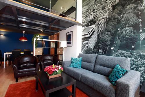 a living room with a couch and a table at Marina Loft & Apartments in Valencia