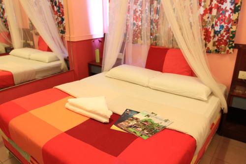 a bedroom with two beds and a mirror at La Mode (Sophia) Hotel in Singapore