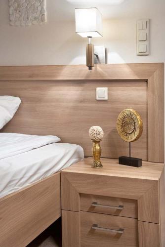 a bedroom with a bed and a table with a fan at Hotel Stara Kamienica in Piekary Śląskie
