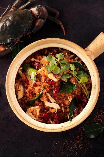 a bowl filled with rice and greens on a table at Artyzen Habitat Dongzhimen Beijing in Beijing