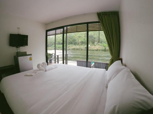 Postel nebo postele na pokoji v ubytování Baan Krupong
