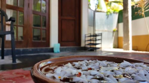 a bowl of rice in front of a door at Era Holiday House in Mirissa