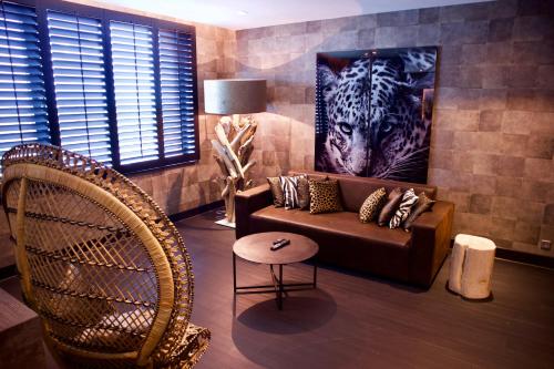 a living room with a tiger painting on the wall at Van der Valk Hotel Utrecht in Utrecht