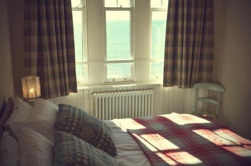 a bedroom with a bed in front of a window at Murray Library Hostel in Anstruther
