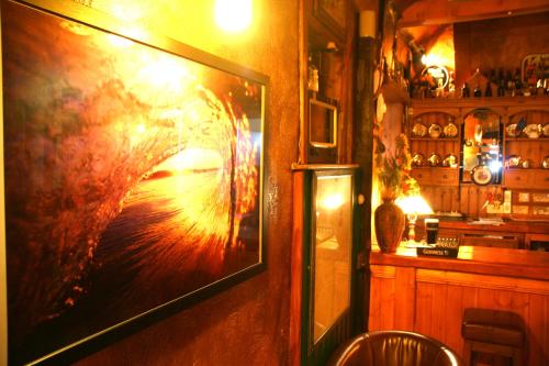 a painting hanging on a wall in a room at Maddens Bridge Bar & Guesthouse in Bundoran