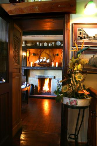 a fireplace in a living room with a fire place at Maddens Bridge Bar & Guesthouse in Bundoran