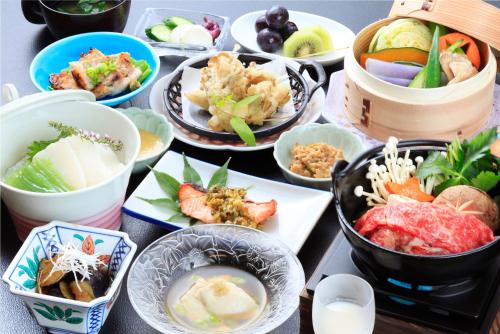 a table topped with bowls of different types of food at Micasa in Minakami