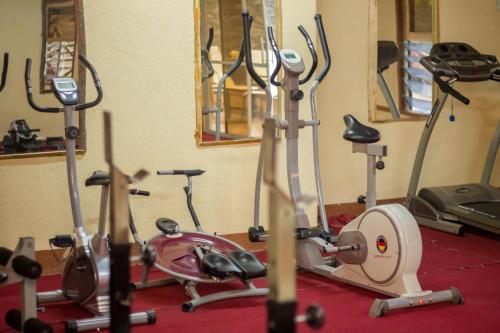 a gym with several exercise bikes in a room at Dovenest Lodge in Naivasha