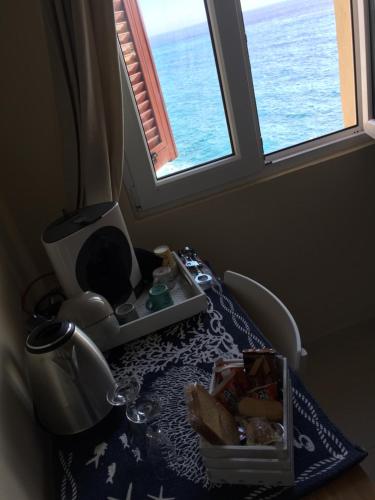a table in a room with a view of the ocean at Le Storie di Manarola in Manarola