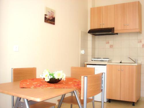 a kitchen with a table and chairs with a table and a table at Dorana Apartments & Trekking Hotel in Diafani