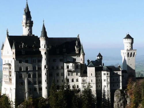 a castle sitting on top of a mountain at Landhaus & Pension Christian in Füssen