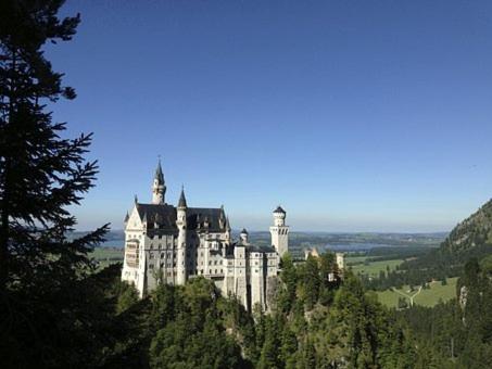 a large castle on top of a mountain at Landhaus & Pension Christian in Füssen