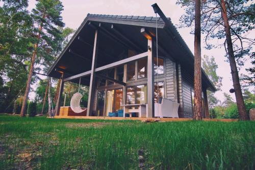 a house with a black roof and windows at Hapsal Spa Villas in Haapsalu