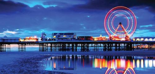 a ferris wheel on a pier at night at The Galloway in Blackpool