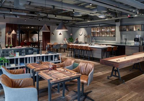 a restaurant with tables and chairs and a bar at Downtown Camper by Scandic in Stockholm
