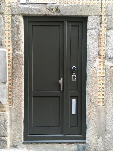 a door is open and a person is standing by it at 2U Oporto Urban Stays in Porto
