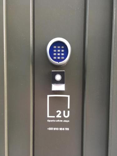 a blue and white sign on the side of a metal door at 2U Oporto Urban Stays in Porto