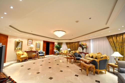 a hotel lobby with couches and chairs at Hayah Grand Hotel Ex Al Jaad Madinah Hotel in Medina