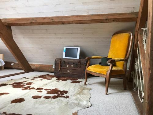 a room with a chair and a desk with a computer at Glatigny Farmhouse - close to beach - proche de la plage in Glatigny