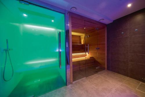 a bathroom with a shower with a glass door at Koru Hôtel & Private Wellness in Autre-Église