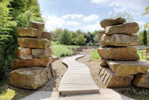 a path made out of rocks and a stack of stones at Koru Hôtel & Private Wellness in Autre-Église