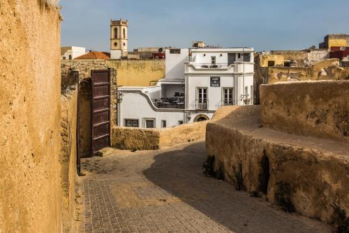 an alley in a city with buildings in the background at Hotel L'Iglesia in El Jadida