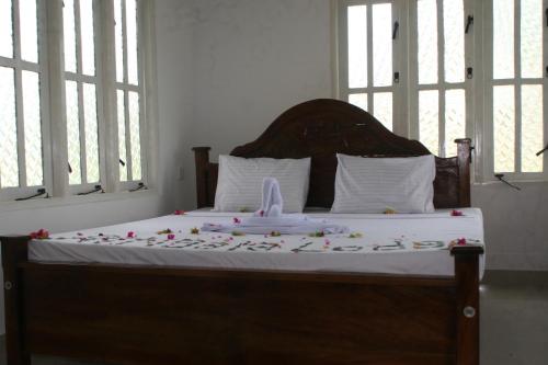 a bed with a stuffed animal on top of it at Ritigala Lodge in Habarana