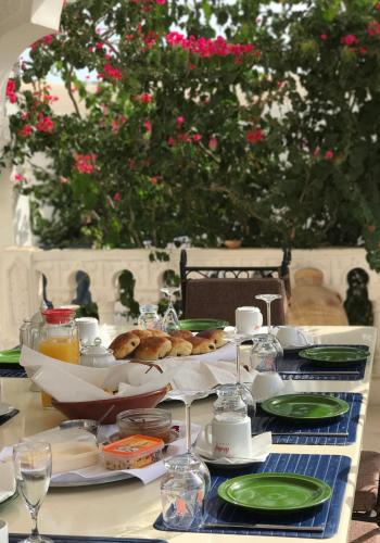 a table with a plate of food on it at Menzel Churasco Djerba in Aghīr