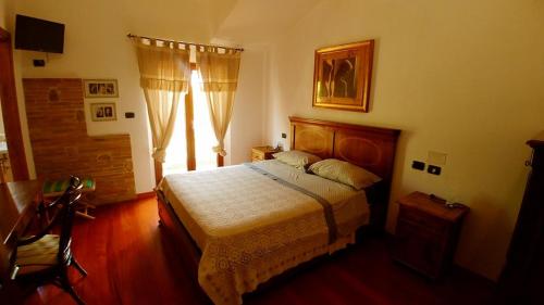 a bedroom with a bed and a large window at Casale del Sole in Cepagatti