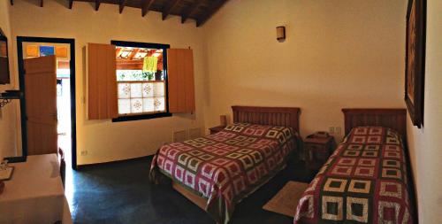 A bed or beds in a room at Pousada Villa Parahytinga