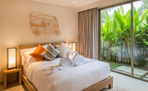 a bedroom with a bed with a vespa on it at Villa Desi in Bang Tao Beach