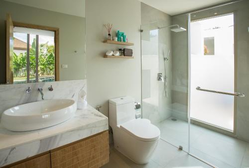 a bathroom with a sink and a toilet and a shower at Villa Desi in Bang Tao Beach