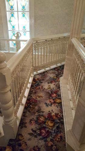 a hallway with a staircase with a floral carpet at Hotel Elegance (Love Hotel) in Karatsu