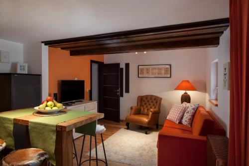 a living room with a table and a couch at The Green House - Luxury Apartments in St. Wolfgang